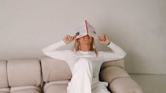 Woman hiding her face with a book